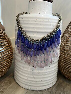 Anthropologie statement necklace with layers of blue beads on brass chain